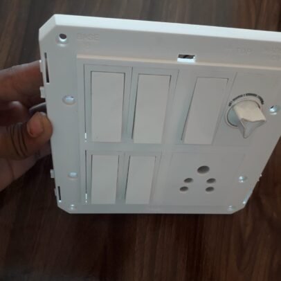White modular electrical switch board with fan regulator and socket panel