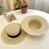 Elegant natural straw wide brim hat for women with decorative black band for beach travel and summer outdoor fashion