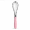 Stainless steel balloon whisk with pink ergonomic handle for egg beating baking and kitchen mixing.